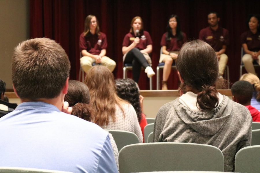 Prospective students look on as several emissaries speak on various topics.