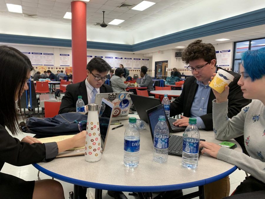 Debate members gather to make final notes before starting the tournament.