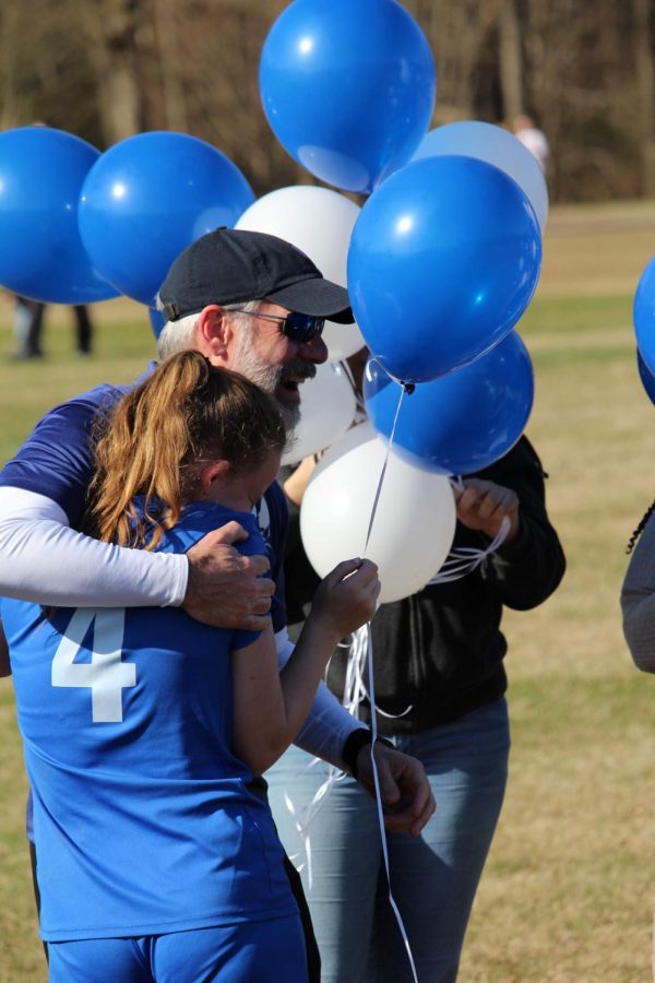 Senior Samantha Broussard hugs Coach Yarborough at the Senior Day celebration. 