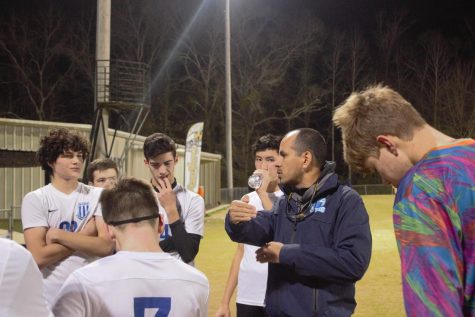Coach Armando Leyva gives instructions to members of the boys team.