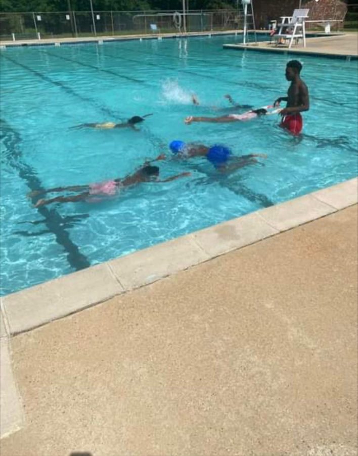 Junior Dylan Wiley volunteers his time to give free swim lessons to kids in the Jackson area.