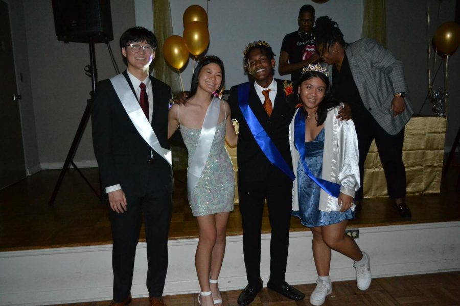 Winter Formal Royalty pose for photo in front of the stage. Pictured from left to right is junior Ean Choi, junior Lisa Seid, senior CJ Mason and senior Kadie Van. 