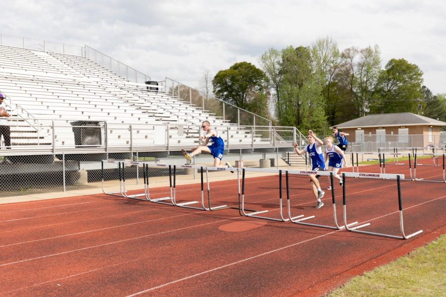 Senior Jon Keisel (farthest left) and junior Marqueveon Quinn (third back) participate in the hurdles during the Columbus Invitational on April 4.
