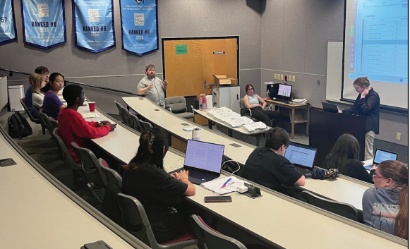 Journalism I, Journalism II and Vision club members discuss story ideas in
Hooper Auditorium. The dedication of The Visions staff wirters, editors and advisor have led to its recognition at the annual Mississippi Scholastic Press Association Best-of-Journalism Spring Convention.