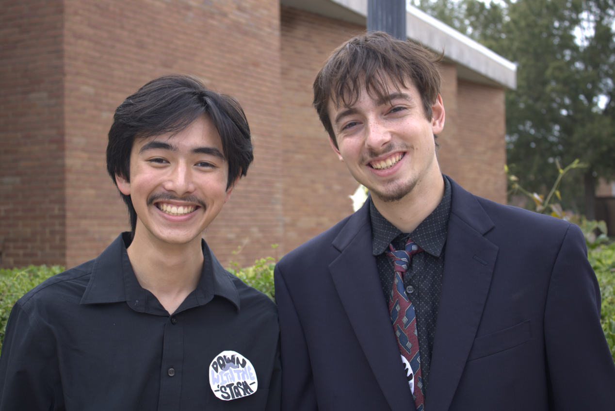 Math Outreach President Noah Lee (left) and English Outreach President Sebastian Harvey pose outside Hooper Academic Building before the Mustache Funeral begins. Lee and Harvey organized the fundraiser on Sept. 8 to benefit both outreach clubs.
