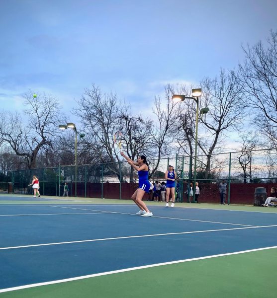 Junior Darshi Kher (left), with senior Iris Xue, returns a ball in her doubles one match against South Pontotoc on Feb. 15.
