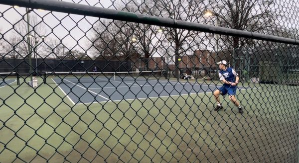 Junior Ryan Wu returns a shot in his singles match against New Hope on Feb. 26. The Blue Waves won 5-2 at home against New Hope on Feb. 26, marking its second triumph of the season.