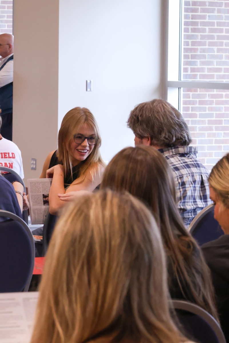 Sports Editor Mariane Powell (left) talks to advisor Carl Smith at the Miss Scholastic Press Association during its annual conference in early April. 