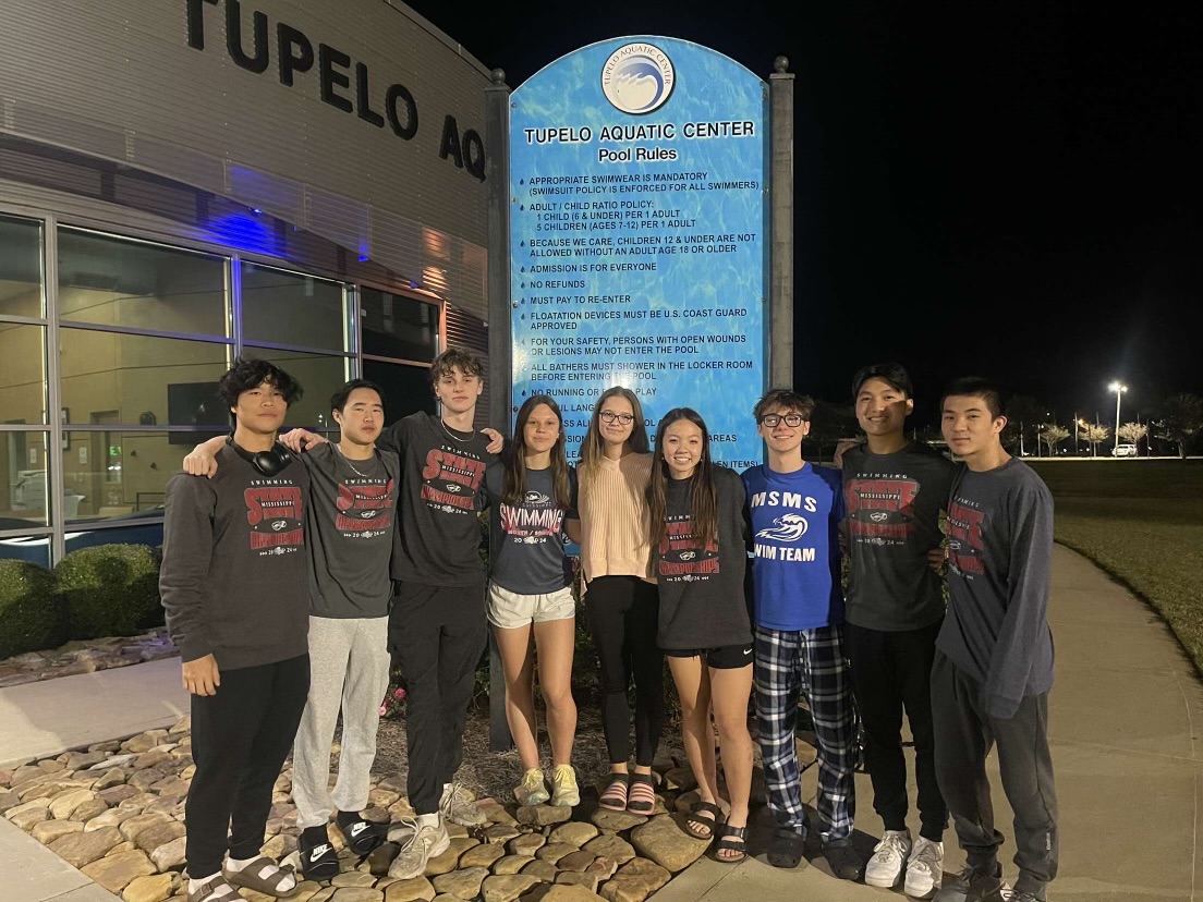 Pictured from left to right: Ryan Wei, Harrison Shao, Max Thompson, Cassie van Riessen, Kayla Williams, Isabel Beckman, John Broome, Raymond Yang and Grant Zhang pose at the Tupelo Aquatic Center after their state championship meet.