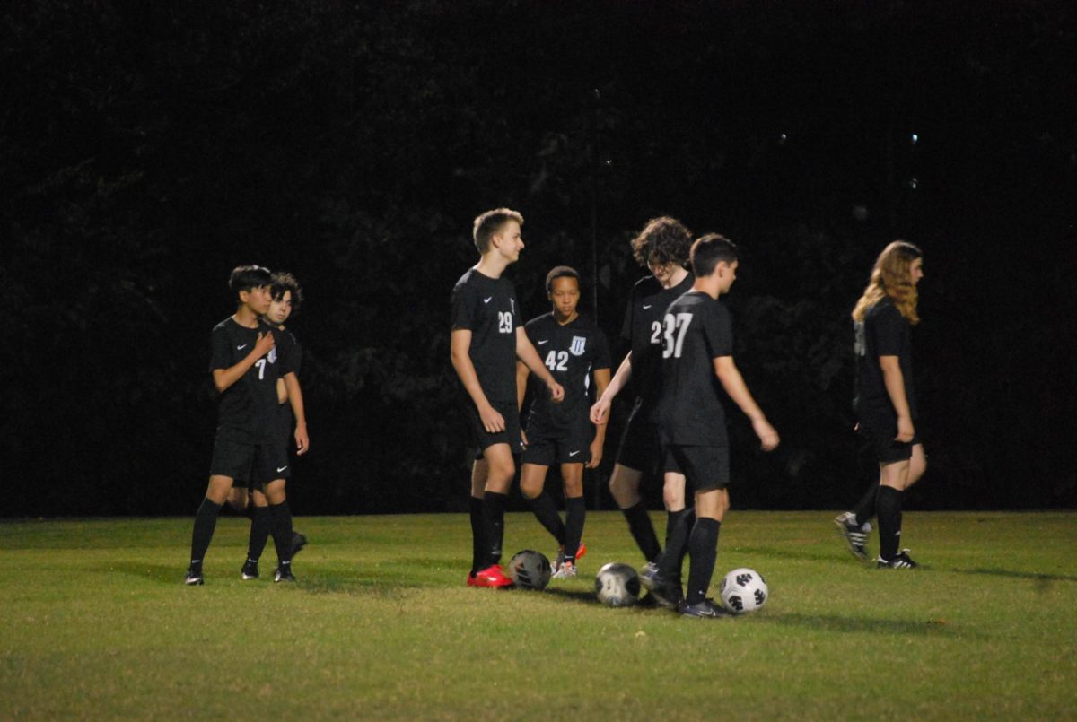 Juniors Minh Nguyen, Jake Heisler, Aaron Lawson, Christian Butler, Ashton Spence, JT Sistrunk and Liam Daigle warm up with pre-game drills.