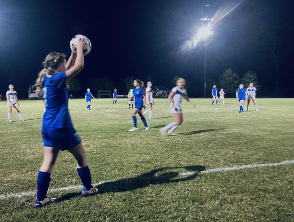 Senior Cloe Wilkes throws the ball back into play against Columbus High School on Nov. 5.