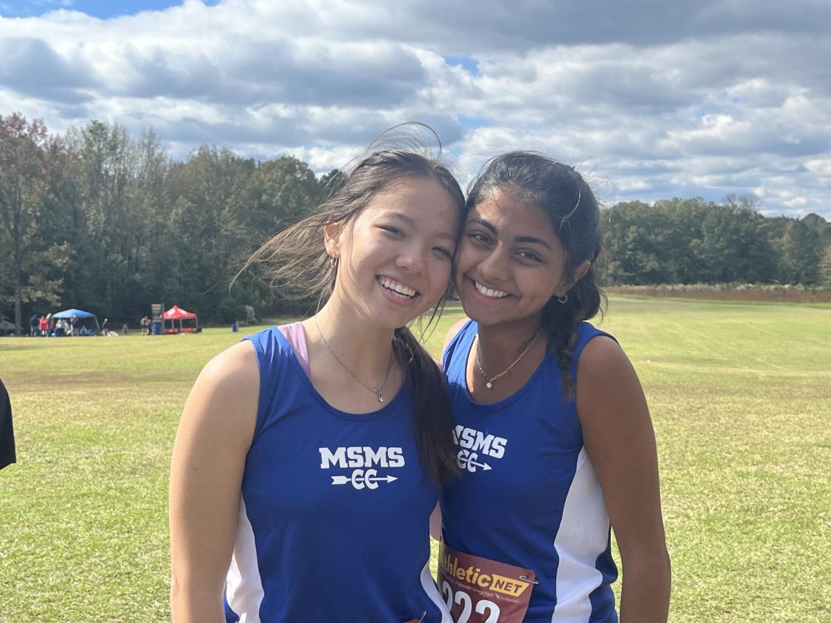 Seniors Isabel Beckman, left, and Aanya Banga pose at the MHSAA State Cross Country Championships.