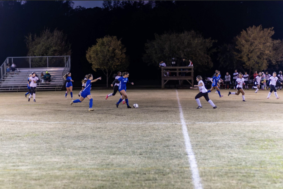 Senior Goen player Natalia Elmore dribbles the ball at midfield joined by senior teammates Isabel Beckman and Sophia Dean (left). Goen's season ended in February with a postseason loss against Vardaman.