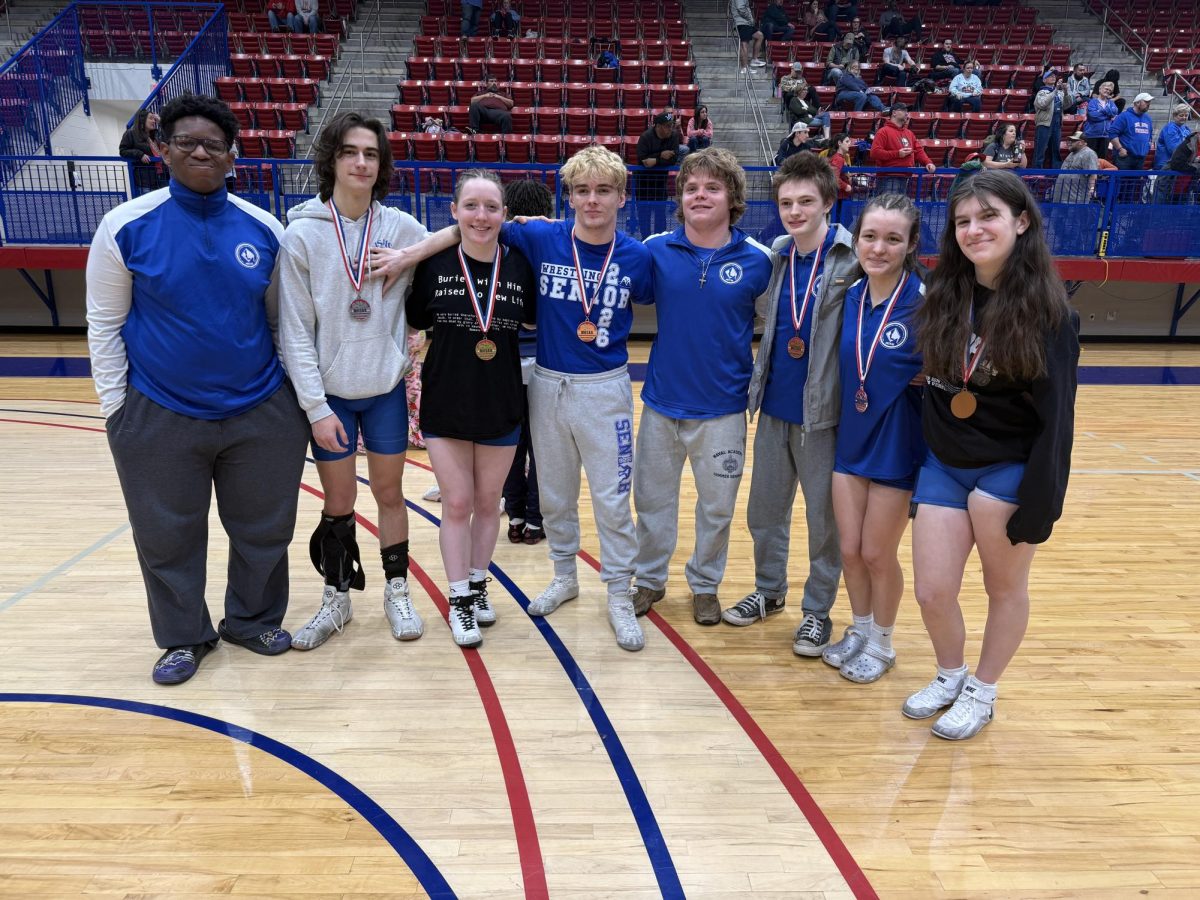 MSMS wrestlers pose at the North State Championship. From left: junior Branston Harewood, seniors Owen Williams, Nina Weinstein, Enoch Clardy, Shaw Prewitt, Ross Chism, Annabelle Banda and junior Harper Hipp. (Courtesy of Nina Weinstein)